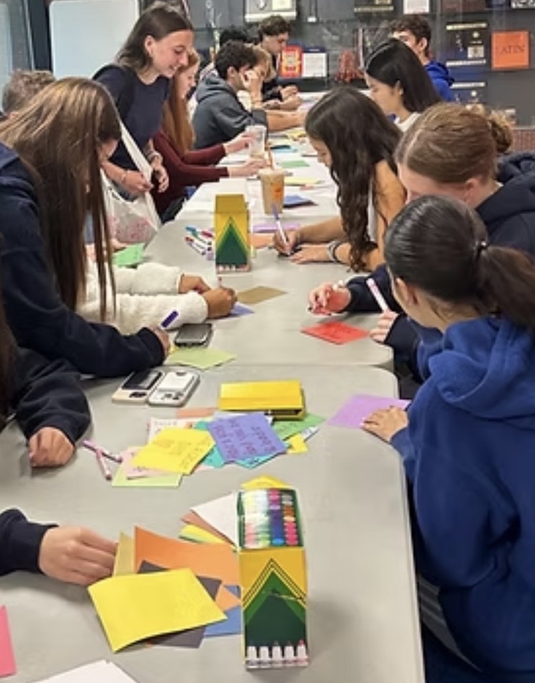 Volunteers writing encouraging notes